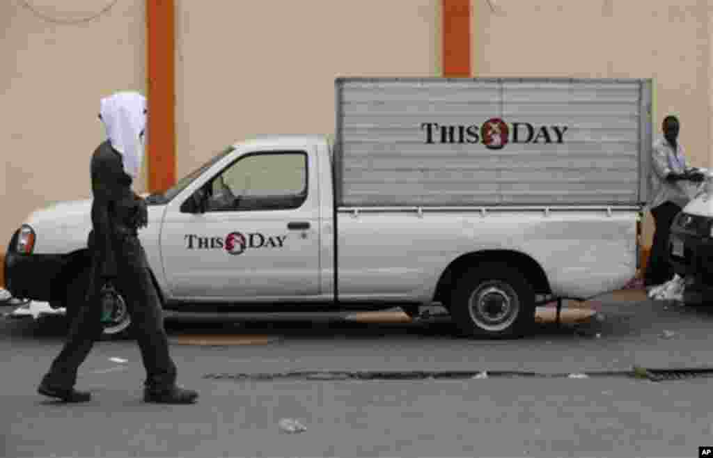 A member of staff from  This Day newspaper walks past a delivery van as workers barricaded the office due to non payment of salaries in Lagos, May 10, 2013.