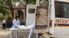 Health workers carry the body of a person, who died from complications related to the COVID-19, for cremation at a crematorium in New Delhi, India, June 10, 2021.