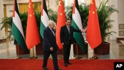 FILE - Chinese Premier Li Qiang, right, receives Palestinian President Mahmud Abbas at the Great Hall of the People in Beijing on June 15, 2023. 