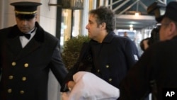 FILE - Michael Cohen arrives at his home in New York with his left arm in a sling supported by a pillow, Jan. 18, 2019.