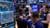 Specialist Genaro Saporito, foreground, works with traders at his post on the floor of the New York Stock Exchange, Sept. 18, 2024. 