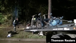 The remains of a Tesla vehicle are seen after it crashed in The Woodlands, Texas