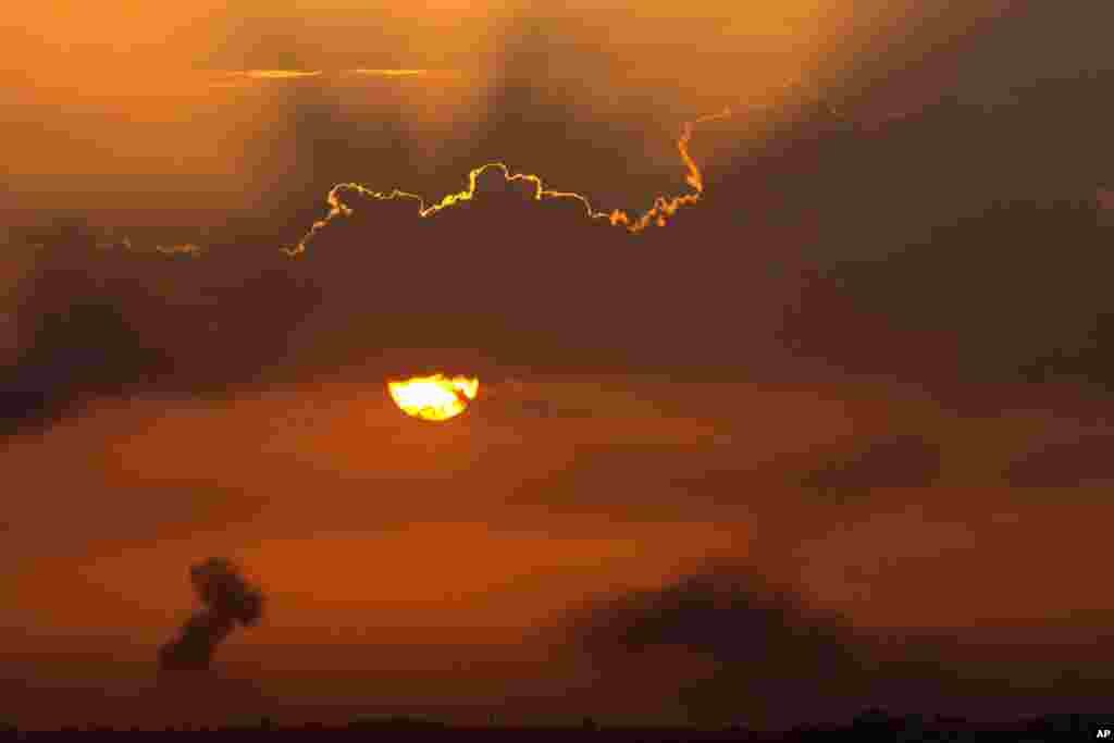 In this image made from video provided by KOMO-TV, smoke rises from the scene of a news helicopter crash outside the KOMO-TV studios near the space needle in Seattle, Washington. The station said the chopper was apparently coming in for a landing on its rooftop when it possibly hit the side of the building and went down, hitting several vehicles.