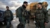 Israeli soldiers light a candle on the seventh night of Hanukkah before being deployed to the Gaza Strip near the Israeli-Gaza border in southern Israel, Dec. 31, 2024. 