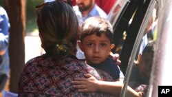 A child from Honduras is brought to the United States Immigration and Customs Enforcement office in Grand Rapids, Michigan, July 10, 2018.