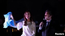 Argentine President-elect Javier Milei and Vice President-elect Victoria Villarruel greet supporters after winning Argentina's runoff presidential election, in Buenos Aires, Argentina, Nov. 19, 2023. 