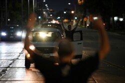 FILE - Demonstrators take part in a protest following the police shooting of Jacob Blake, a Black man, in Kenosha, Wis., Aug. 26, 2020.