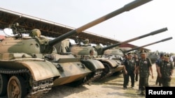 Cambodia's Deputy Prime Minister and Defence Minister Tea Banh (2nd R) inspects tanks inside the Army Institute after a graduation ceremony at Army Institute in Kampong Speu province March 12, 2015. 