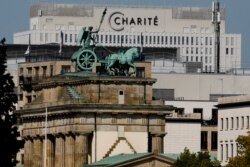 The Quadriga on top of Germany's landmark Brandenburg Gate seen in front of the central Charite building, where Russian opposition leader Alexei Navalny is being treated, in Berlin, Germany, Sept. 14, 2020.