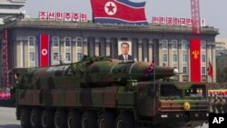 A North Korean vehicle carrying a missile is seen by during a military parade in Pyongyang, April 15, 2012.