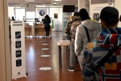 FILE - People stand in line at the "Pole Emploi" agency of Chateau-Gombert in Marseille, southern France, on Dec. 14, 2020.