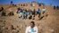 Miners gather at a hill known as the "Hill of Horror" ahead of the one-year anniversary commemorations to mark the killings of 34 striking platinum miners shot dead by police outside the Lonmin's Marikana platinum mine in Rustenburg, South Africa, Aug. 16