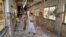 FILE - A Pakistani paramilitary soldier and a nurse walk through a corridor at the Bolan Medical complex damaged by an attack claimed by the Sunni militant group Lashkar-e-Jhangvi, in Quetta, Pakistan, June 16, 2013. Masroor Nawaz Jhangvi, son of Lashkar-e-Jhangvi's slain founder, has won the Jhang district by-election for a seat in the Punjab Assembly.
