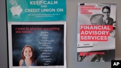 Fliers offering financial advising services to clients hang in a cubicle at the Neighborhood Trust Federal Credit Union in Washington Heights in New York, May 24, 2018.