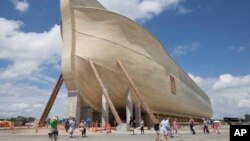 Visitors pass outside the front of a replica Noah's Ark at the Ark Encounter theme park in Williamstown, Kentucky, July 5, 2016. 