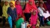 FILE - Some of around 20 Somali refugee families wait to be flown to Kismayo in Somalia, under a voluntary repatriation program, at the airstrip of Dadaab refugee camp in northern Kenya, Dec. 19, 2017.