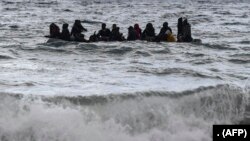 A dinghy transporting 27 refugees and migrants originating from Gambia and the Republic of Congo is pulled towards Lesbos island after being rescued by a war ship during their sea crossing between Turkey and Greece on February 29, 2020. (Photo by ARIS MESSINIS / AFP)