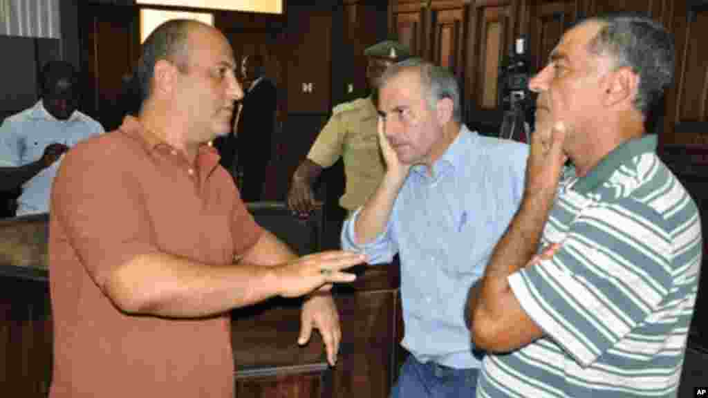 Talal Ahmad Roda, Left, Abdallah Thahini, centre, Mustapha Fawaz, right, talk before a court verdict at the Federal High Court in Abuja, Nov. 29, 2013.