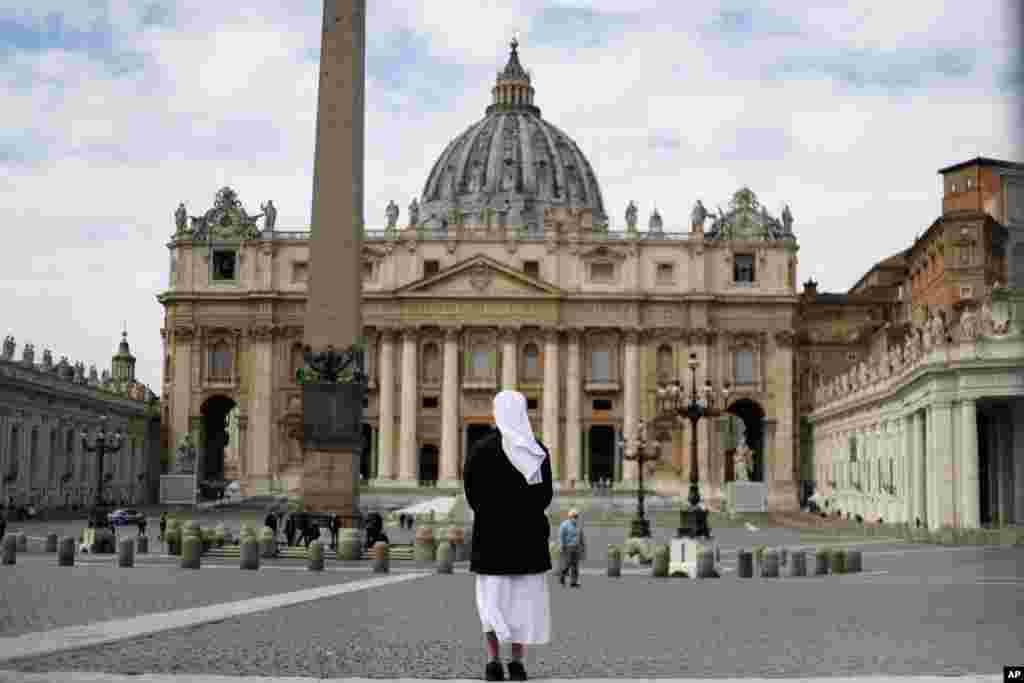 A nun stands in St. Peter&#39;s Square at the Vatican.