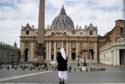 FILE - A nun stands in St. Peter's Square at the Vatican in March 2021.