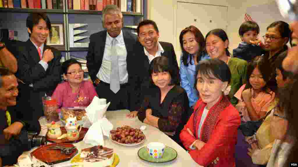 Members of the VOA Burmese Service, including Service Chief Than Lwin Htun (top left) and Kyaw Zan Tha (center), gathered around their guest as she praised VOA for providing Burma with balanced news and information.