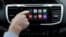 FILE - Chris Martin from Honda North America demonstrates Apple CarPlay, which lets drivers use an iPhone and its voice-activated assistant, Siri, to operate some of their vehicle’s electronic controls and entertainment systems, in Torrance, Calif., August 20, 2015.