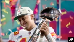 FILE:Kansas City Chiefs quarterback Patrick Mahomes (15) holds the trophy after their win against the Philadelphia Eagles in the NFL Super Bowl 57 football game, Sunday, Feb. 12, 2023, in Glendale, Ariz. The Kansas City Chiefs defeated the Philadelphia Eagles 38-35.