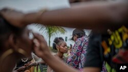 FILE - Models get made up during the ninth edition of the Liputa fashion show in Goma, Democratic Republic of Congo, Saturday June 24, 2023