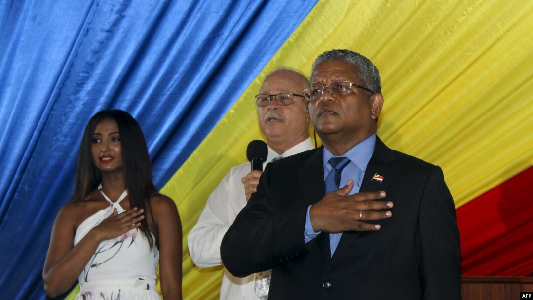 Newly elected president of the Seychelles Wavel Ramkalawan (R), the 5th president of the island nation, looks on next to supporters at the State House during his inauguration in the capital Victoria in the Seychelles, Oct. 26, 2020.