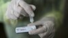 FILE - A health care worker holds a rapid COVID-19 antigen test at a coronavirus testing center in Nice, France, Oct. 15, 2020. Millions of such kits are heading to Africa for distribution.