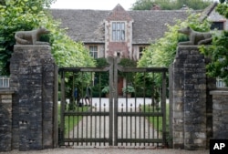 A gate protects the entrance of the Rooksnest estate near Lambourn, England, Aug. 6, 2019. The manor is the domain of Theresa Sackler, widow of one of Purdue Pharma’s founders and, until 2018, a member of the company’s board of directors.