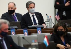 U.S. Secretary of State Antony Blinken, rear center, waits for the start of a round table meeting of NATO foreign ministers at NATO headquarters in Brussels, March 23, 2021.