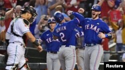 Texas Rangers shortstop Geraldo Perdomo (2) celebrates with left fielder Tommy Pham (28) after scoring a run in the ninth inning against the Arizona Diamondbacks. The Rangers won the 2023 World Series in five games. Matt Kartozian/USA TODAY Sports.