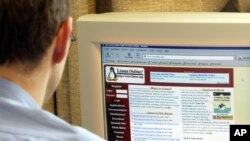 FILE - An employee in the city hall in Munich is watching the webpage of the Linux operating system in Munich, southern Germany, on Tuesday, June 15, 2004.