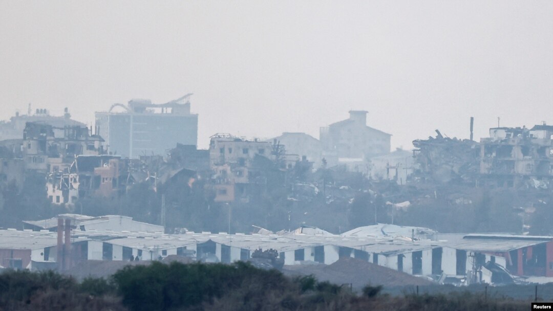 Buildings lie in ruin in Gaza, amid the ongoing conflict between Israel and the Palestinian Islamist group Hamas, as seen from southern Israel, December 13, 2023.