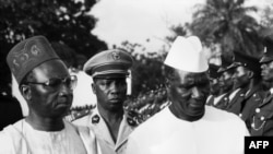 FILE - Ahmed Seku Toure (R), President of Guinea, the new independent state in South West Africa, is greeted in the 1960s in Banjul by Sir Dawda Jawara, President of Gambia. 
