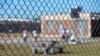 FILE - Detainees sit in a yard during a media tour inside the Winn Correctional Center in Winnfield, La. 