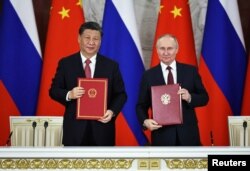 习近平与普京在克里姆林宫签署中俄协议。(2023年3月21日)