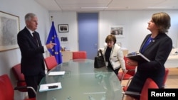 FILE - European Union's chief Brexit negotiator Michel Barnier attends a meeting with Northern Ireland's Democratic Unionist Party (DUP) leader Arlene Foster and DUP member Diane Dodds at the EU Commission headquarters in Brussels, Belgium, Oct. 9, 2018. 