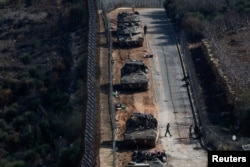 Israeli soldiers gather near the ceasefire line between Syria and the Israeli-occupied Golan Heights, Dec. 9, 2024.