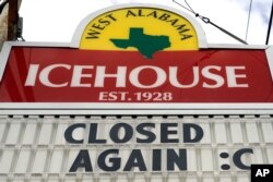 A sign outside the West Alabama Icehouse shows the bar is closed, in Houston, June 29, 2020.