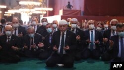 Photo taken on July 24, 2020, by the Turkish Presidential Press service shows Turkey's President Tayyip Erdogan, center, and invited guests attending Friday prayers at Hagia Sophia Grand Mosque in Istanbul. 