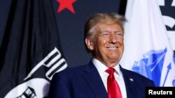 Mantan Presiden AS dan calon presiden dari Partai Republik Donald Trump tersenyum saat kampanye di Windham, New Hampshire, AS, 8 Agustus 2023. (REUTERS/Reba Saldanha)