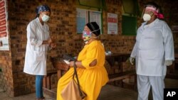 A South African woman is briefed before taking a COVID-19 test in Groblersdal , north-east of Johannesburg, Feb. 11, 2021 as African countries without the coronavirus variant dominant in South Africa are asked to go ahead and use the AstraZeneca COVID-19 