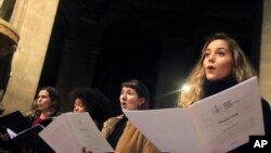 Members of the Notre Dame cathedral choir sing during a rehearsal at the Saint Sulpice church in Paris, Dec. 16, 2019. 