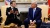 France's President Emmanuel Macron speaks as President Donald Trump listens during a meeting in the Oval Office of the White House in Washington, Feb. 24, 2025.