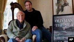 Ernest Hemingway's close friend and biographer A.E. Hotchner, left, poses for a photograph with his son Tim Hotchner, Jan. 22, 2019, in the Hotchner family home in Westport, Conn.