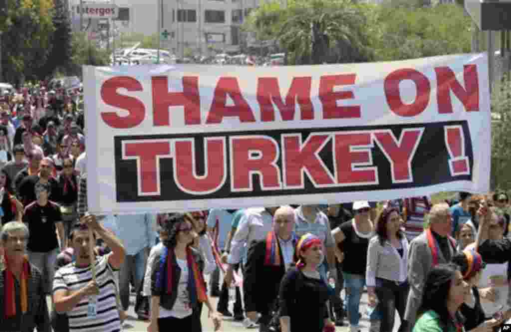 People of Armenian descent hold a banner against Turkey as they march to mark the 97th anniversary of massacres in Turkey that began in April 1915 and in which hundreds of thousands of Armenians died, in Rabiyeh, north of Beirut, Lebanon, on Tuesday, Apri