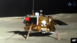 FILE - This photo provided on Jan. 12, 2019, by the China National Space Administration via Xinhua News Agency shows the lunar lander of the Chang'e-4 probe in a photo taken by the rover Yutu-2 on Jan. 11.