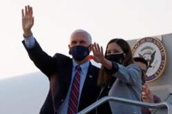 FILE - U.S. Vice President Mike Pence and his wife Karen arrive ahead of the vice presidential debate in Salt Lake City, Utah, Oct. 5, 2020.